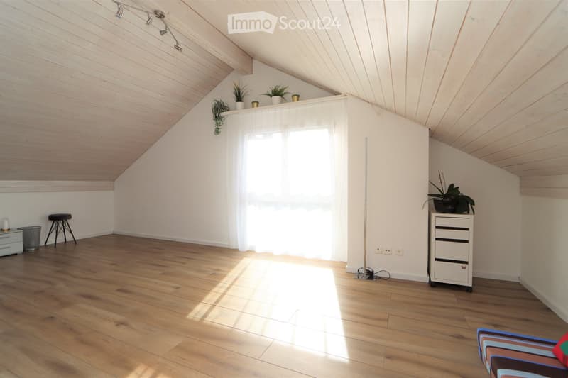 wooden floor, white walls, wooden ceiling, large window with white curtains, potted plants, wooden stool, trash can, small cabinet, sofa