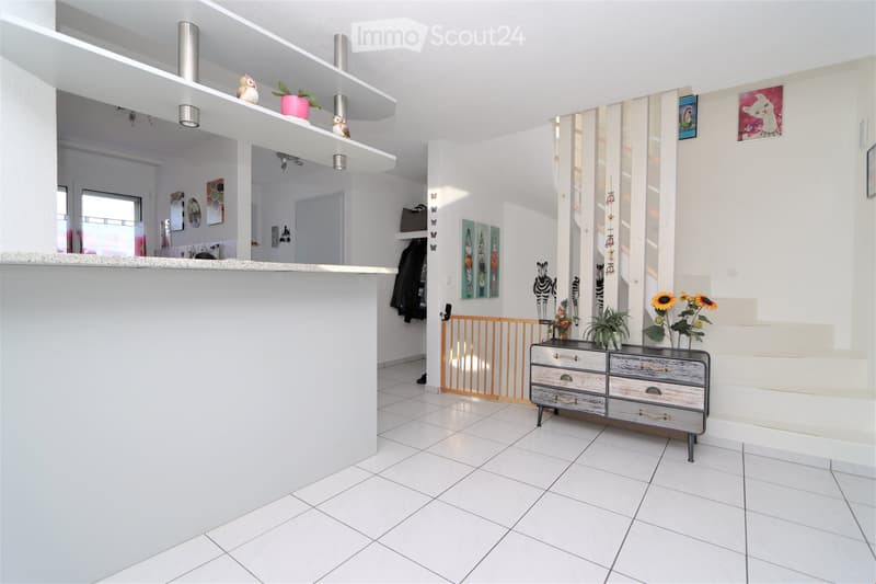modern design, white tiles, white wall, open staircase, wooden cabinet, plant and flowers, pictures
