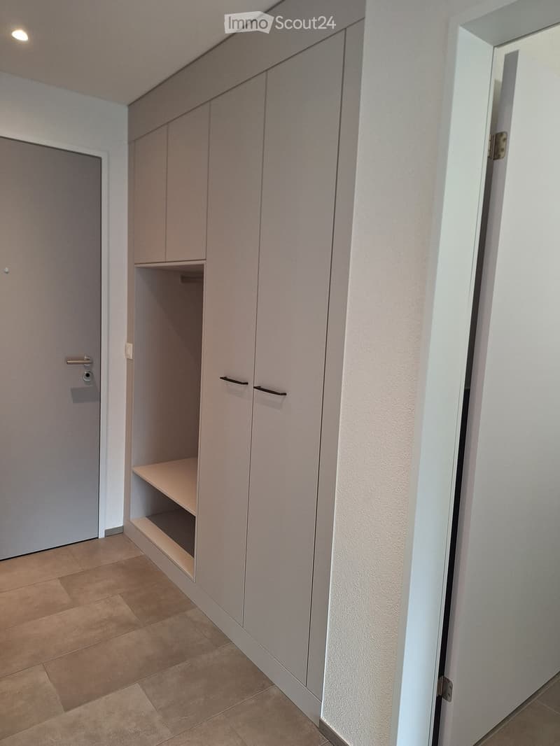 a spacious walk-in closet with sliding doors and built-in shelves
