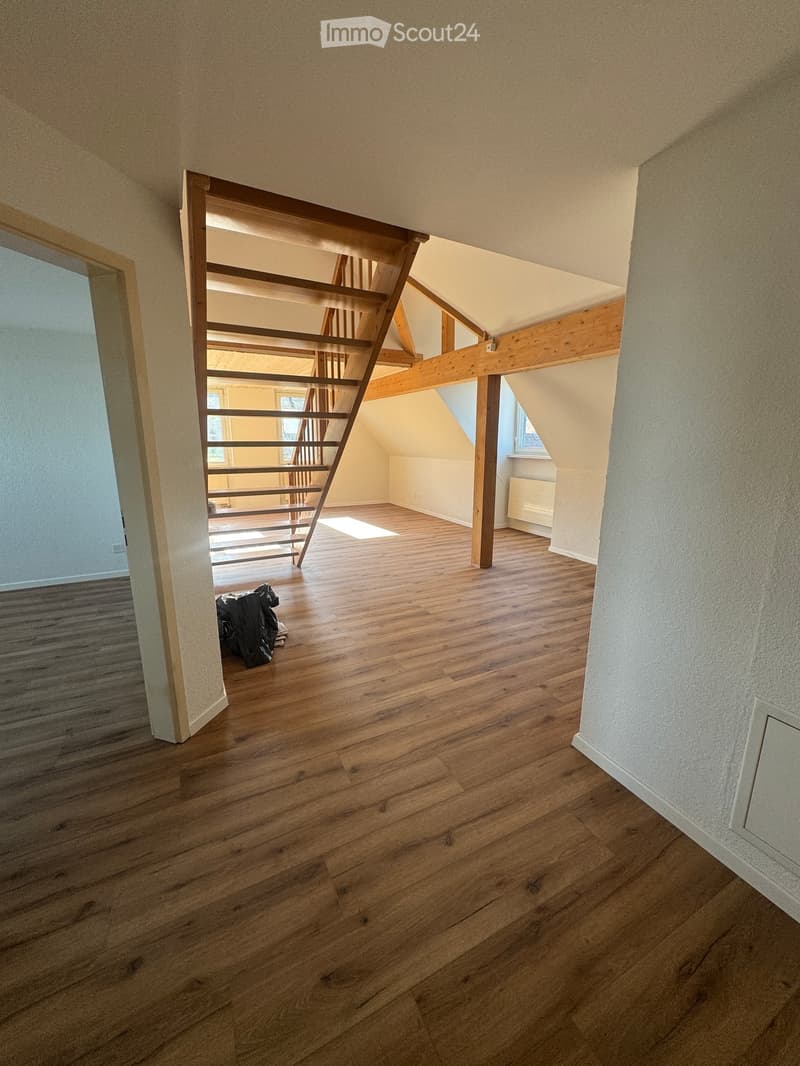 empty room, wooden flooring, wooden stairs, wooden beams, white walls