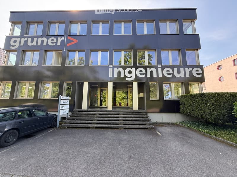 Modern two-story building with dark facade, large windows, and signage reading "gruner ingenieure".
