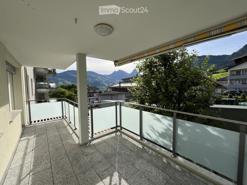 Balcony with tiled floor, metal railing, and scenic mountain view.