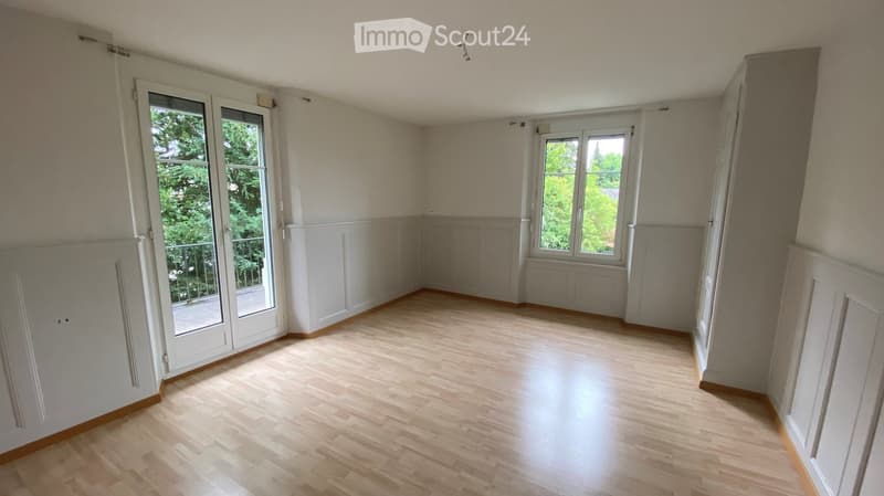 empty room, wooden floor, white walls, two large windows, balcony