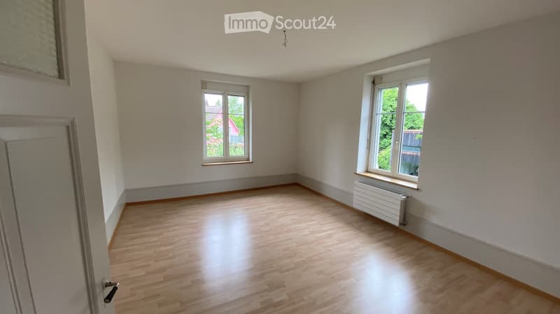 empty room, wooden floor, white walls, two windows, radiator