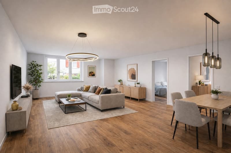Modern living and dining area with a grey sectional sofa, coffee table, dining table with chairs, pendant lights, and a large window with a view.