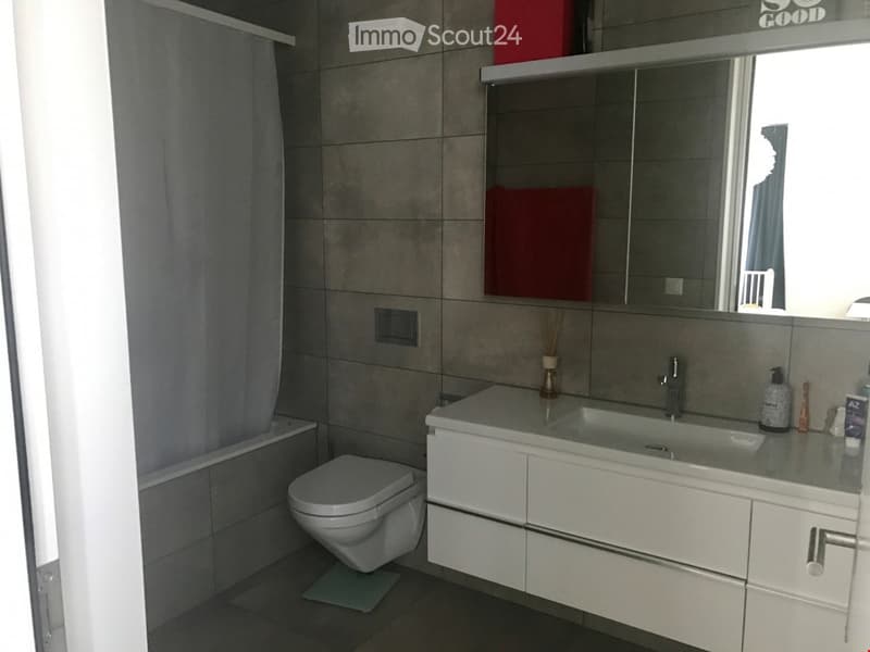 modern bathroom with white tiles, white sink, white toilet, bathtub, mirror, shower curtain