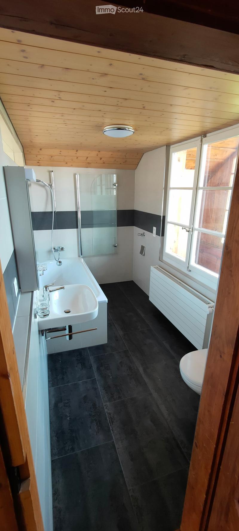 Bathroom with bathtub, sink, toilet, shower, wooden ceiling, white tiles, window