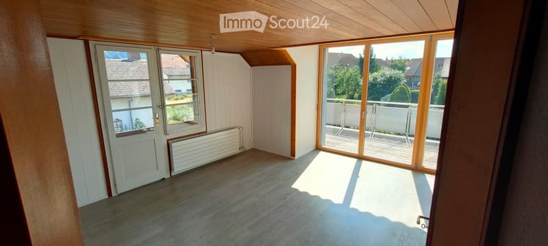 empty room, wooden ceiling, sliding glass doors, balcony, white walls, white door, radiator
