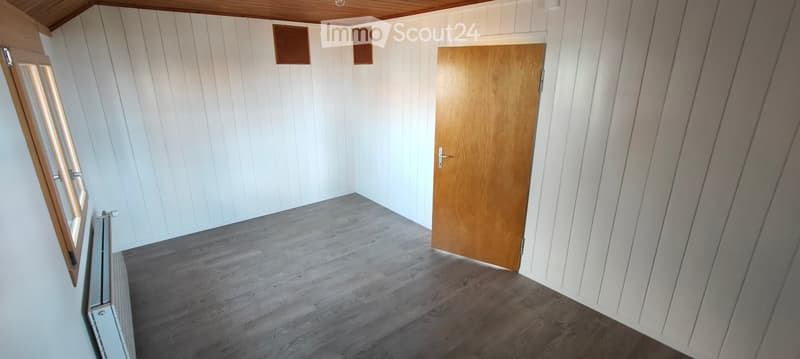 empty room, wooden door, white walls, wooden ceiling, wooden floor, window, radiator