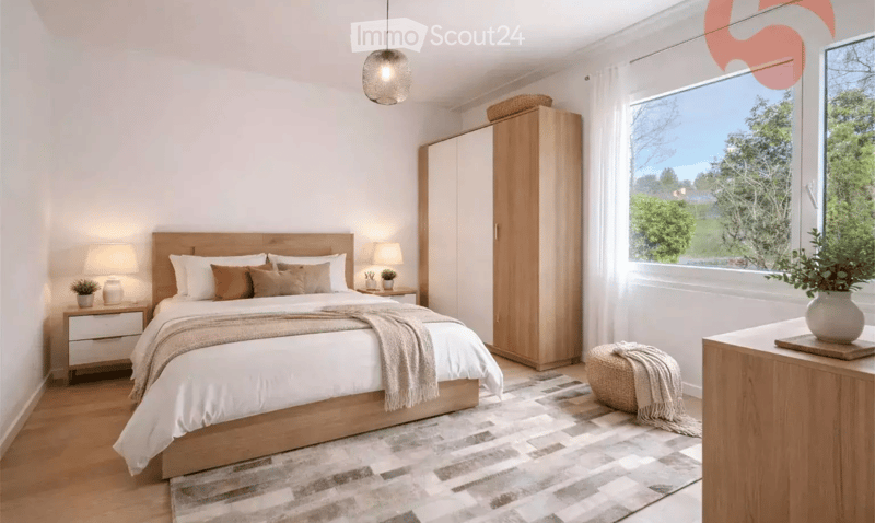 Modern bedroom with a large bed, nightstands, a wardrobe, and a view of greenery outside.