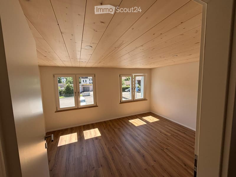 empty room, wood flooring, wooden ceiling, two windows, bright sunlight entering