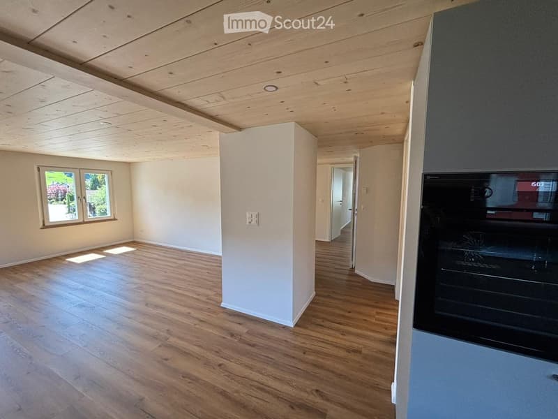 empty room, hardwood floors, white walls, large windows, white column, built-in oven, power outlets, open door