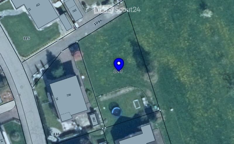 Aerial view of a residential lot with a marked building footprint and surrounding property lines.