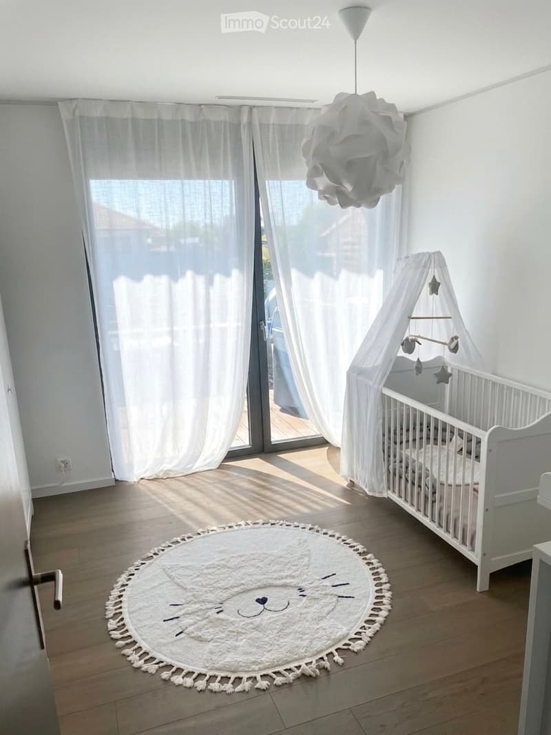white crib, white canopy, white rug, white curtains, white walls, wooden floor, white lamp
