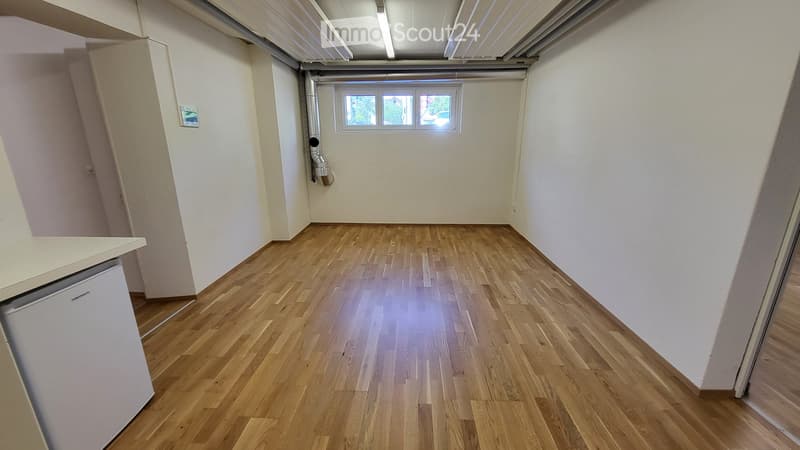 Empty room with wooden flooring, white walls, and a small window at the far end. No furniture or equipment is present.