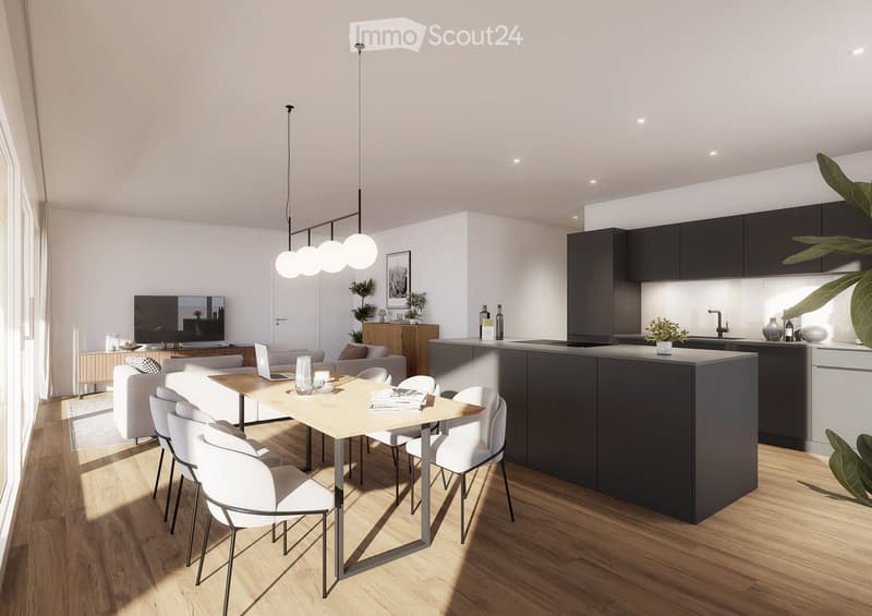 Modern open-plan living and dining area with a light wood dining table, white chairs, a grey sofa, a laptop, and a sleek kitchen island with dark cabinets.