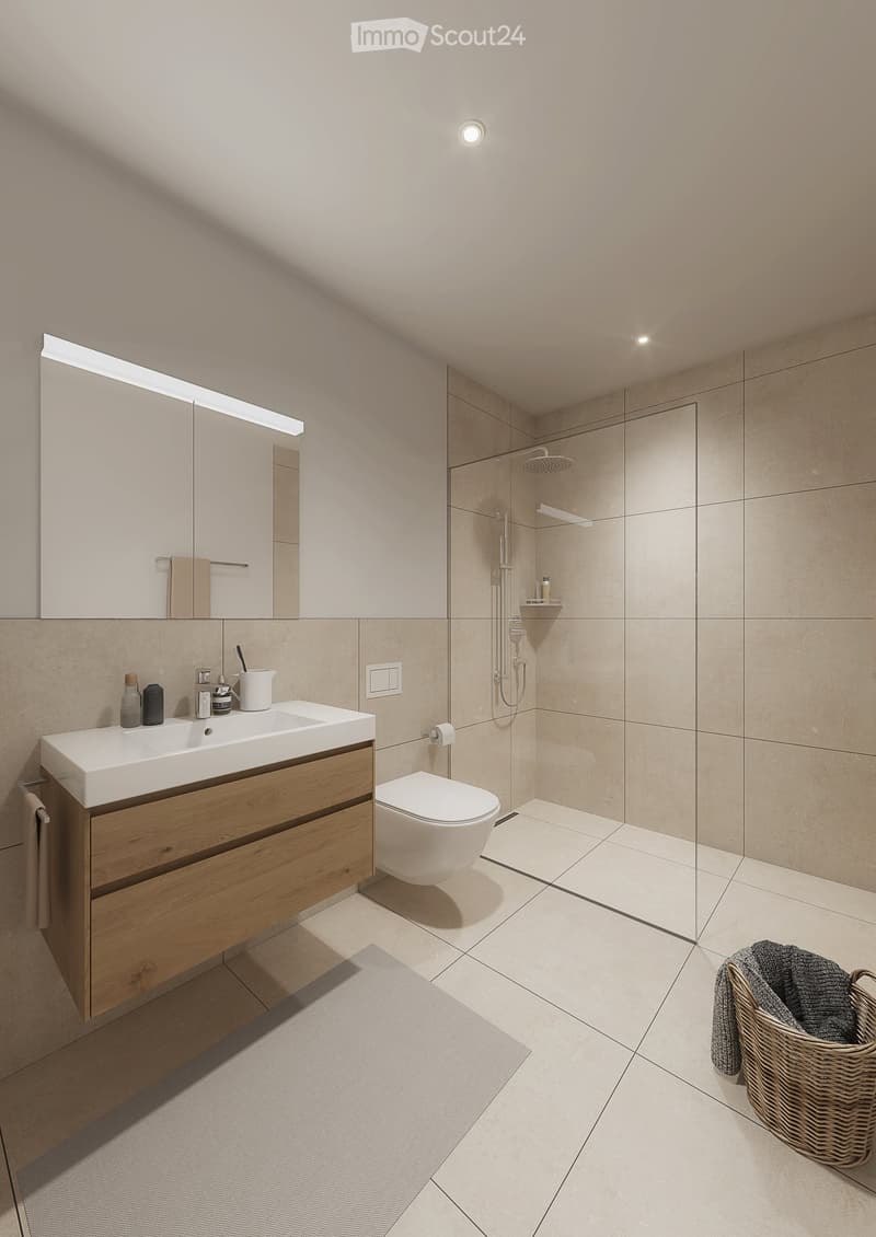 Modern bathroom with a wooden vanity, white sink, toilet, large mirror, and a glass-enclosed shower area.