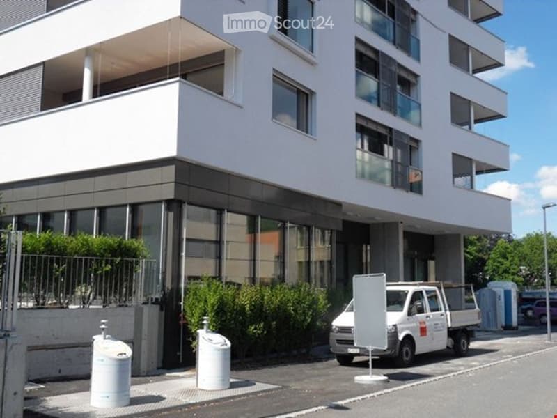 4 story white house, many windows, balcony, parking place