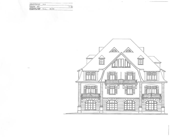 Architectural floor plan of a multi-story residential building with detailed layout, including multiple windows, balconies, and a complex roofline.