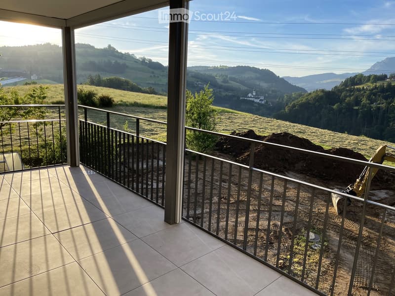 large balcony, metal railings, tiled floor, scenic view of mountains and landscape