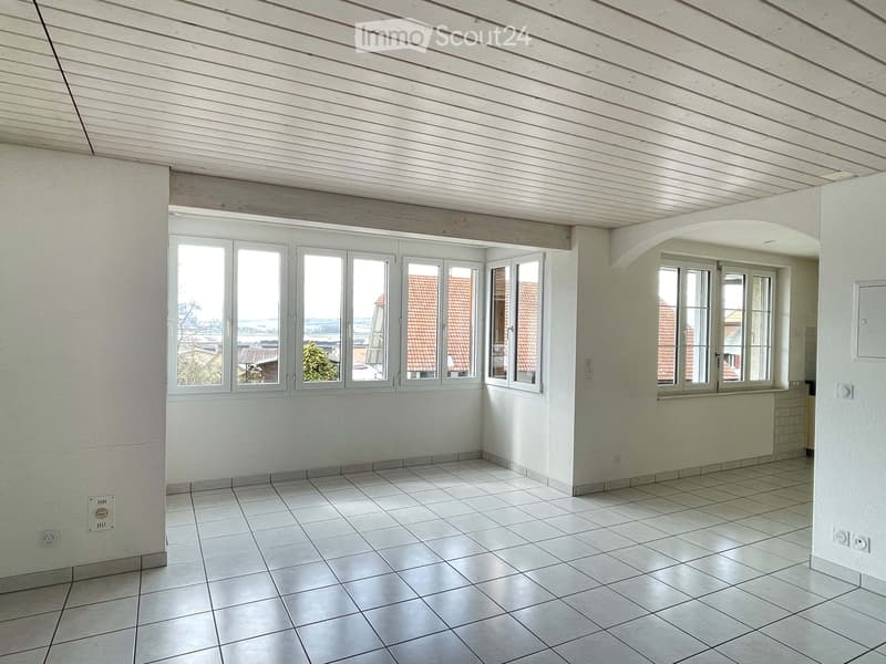 empty room, white walls, white ceiling, white tiled floor, large windows, view of the outside