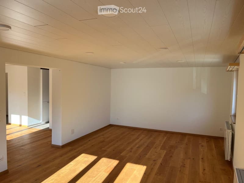 Empty room with wooden flooring, white walls, and recessed lighting. No furniture or equipment present.