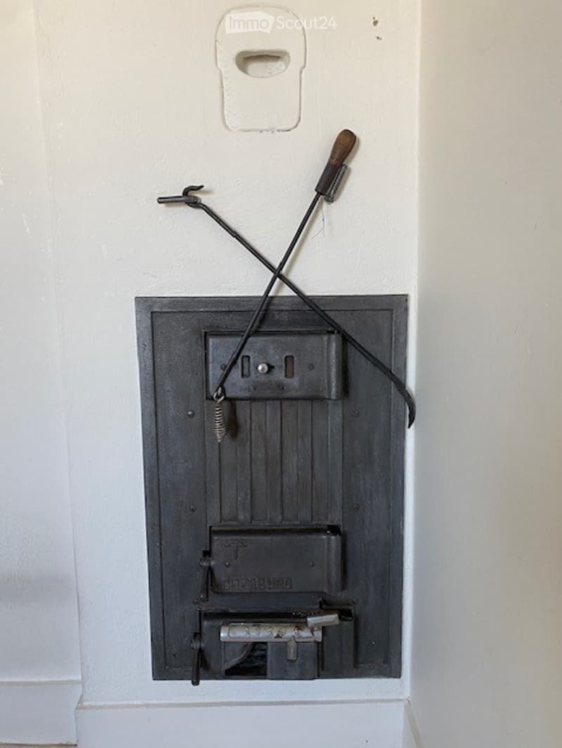 Other. A wall-mounted switch panel with a black switch, a cable, and a hook attached to the wall.
