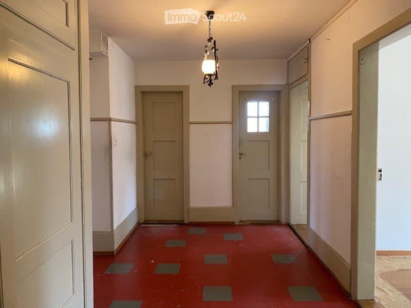 red tiled floor, white walls, light fixture, closed doors
