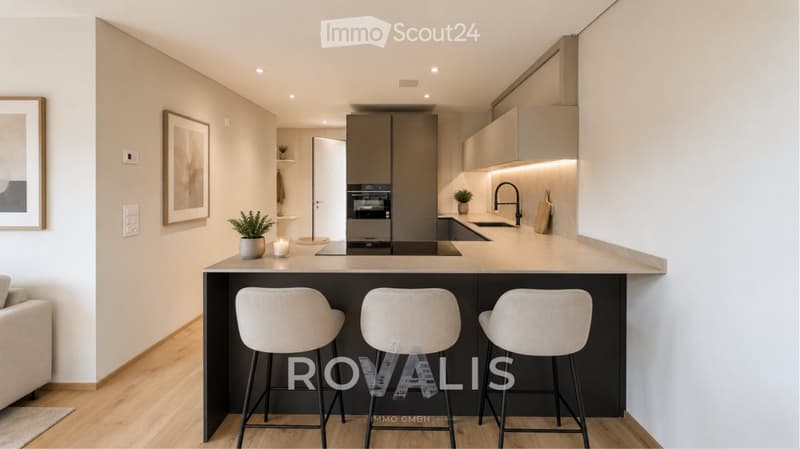 Modern kitchen with a central island, three stools, sink, faucet, oven, and decorative items including a candle and potted plants. The space features light-colored cabinets and a sleek design.