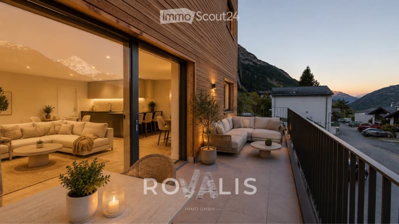 Modern living room with a large sectional sofa, coffee table, and a view of the mountains from a spacious balcony.