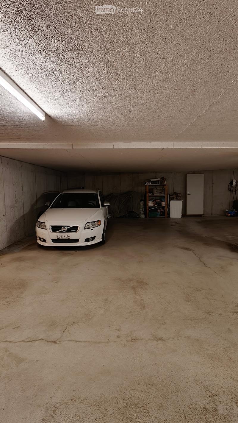 {"visible_features": ["Garage"], "type": "Garage", "objects": ["car", "shelf"], "description": "Underground garage with a white car parked inside, a shelf with various items, and a concrete floor.", "localized_descriptions": {"EN": "Underground garage wit