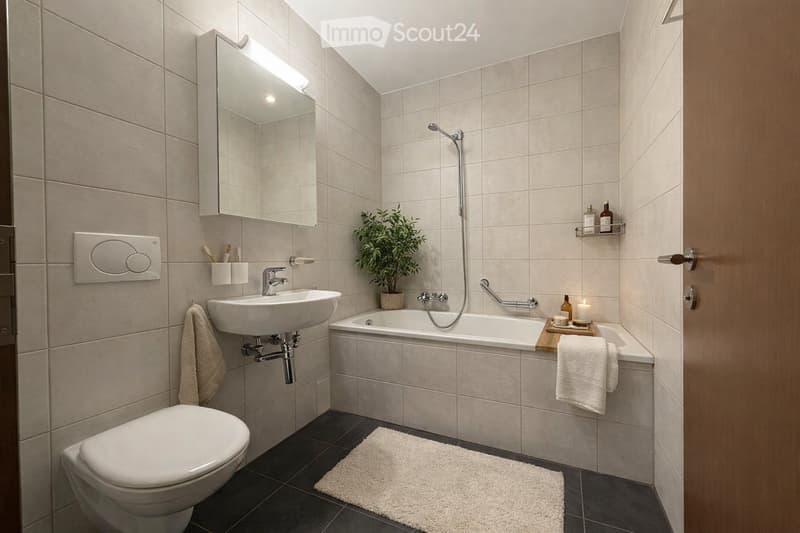 Modern bathroom with a white toilet, sink, bathtub, and mirror. Features a small plant, candles, and a towel on the edge of the tub.