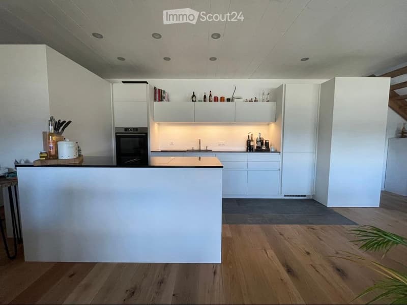 {"type": "Kitchen", "objects": ["refrigerator", "oven", "kitchen island", "cabinets", "faucet", "bottle", "cutting board", "knives", "cupboard", "bottle", "bottle", "bottle", "bottle", "bottle", "bottle", "bottle", "bottle", "bottle", "bottle", "bottle",