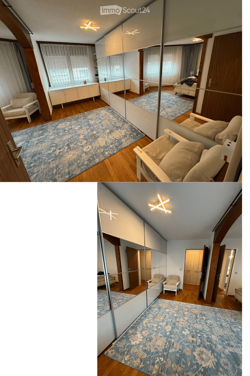 Spacious living room with wooden flooring, large mirror, cream-colored sofa, two armchairs, and a patterned rug.