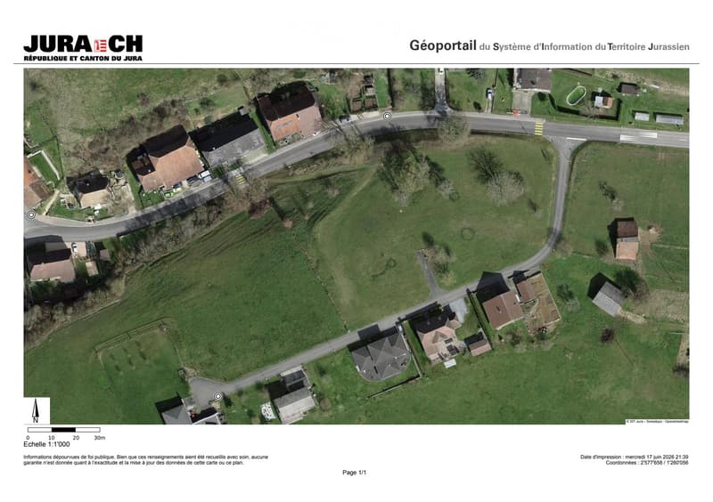 Aerial view of a residential area with multiple houses, roads, and green spaces.
