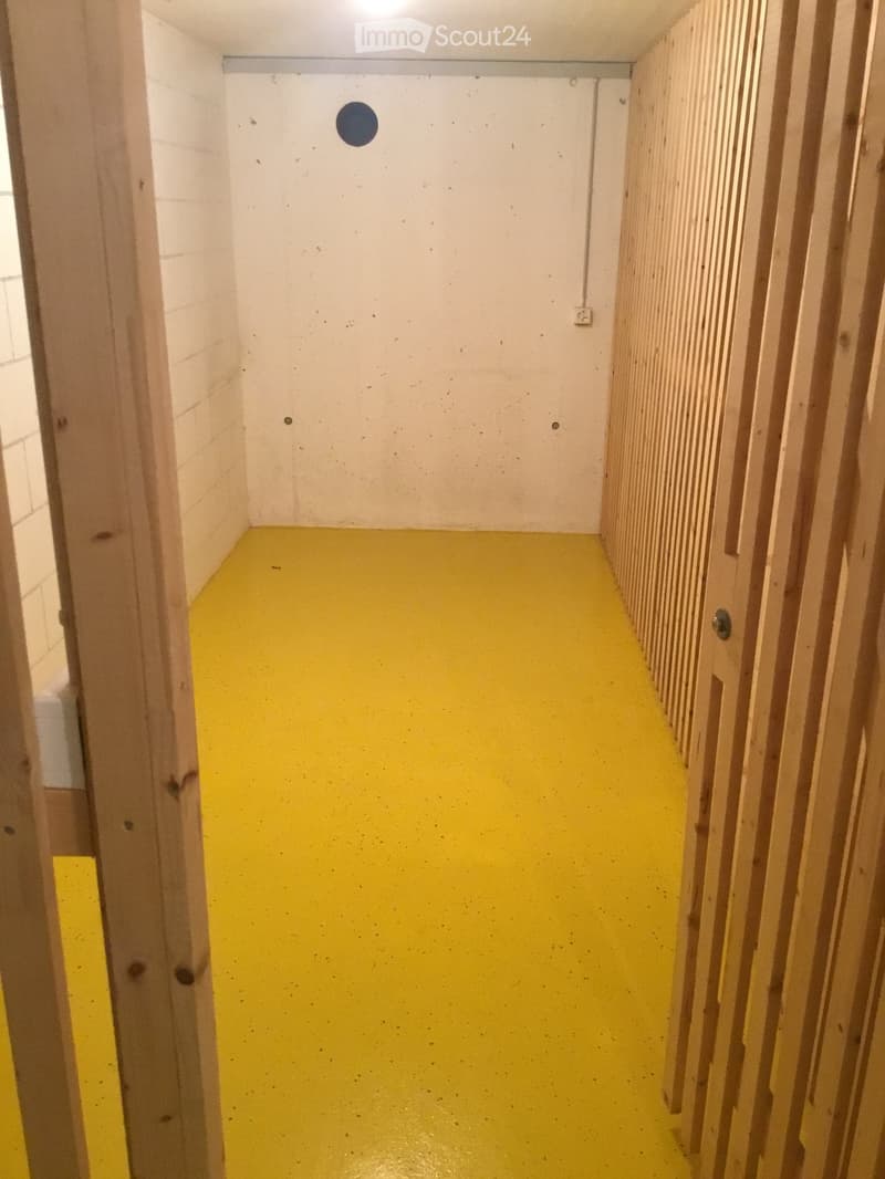 Bright yellow-painted hallway with white walls, wooden paneling on one side, and a visible light fixture on the ceiling.