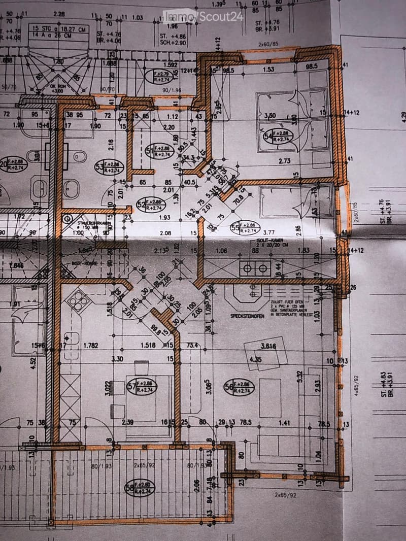 Floor plan showing multiple rooms, including living areas, bedrooms, bathrooms, and a kitchen, with detailed measurements and annotations.