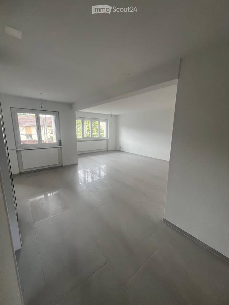 Empty room with white walls, large windows, and a polished tile floor. No furniture or equipment is present.