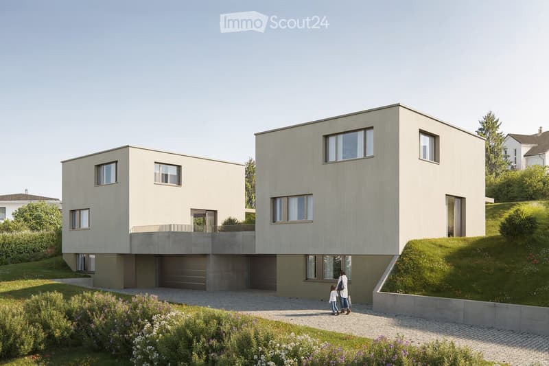 Modern, 2 story, concrete exterior, 2 garages, balcony, greenery around the property