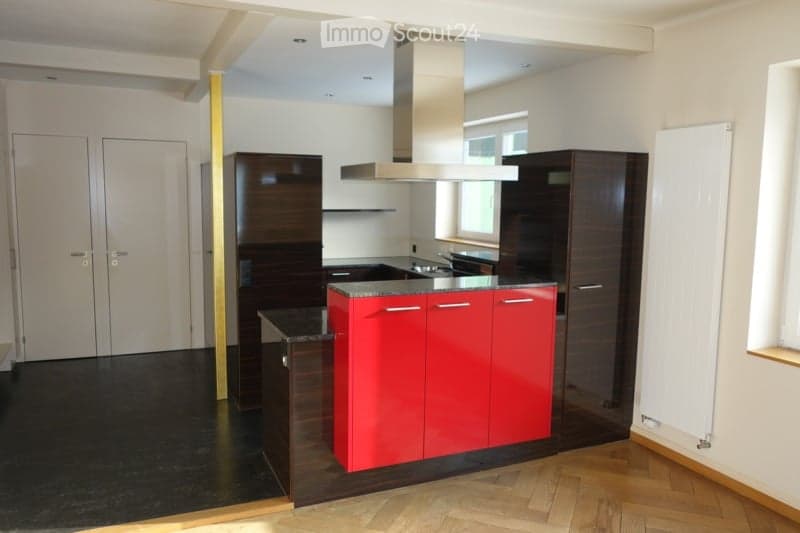 modern kitchen, island, red cabinets, black countertops, stainless steel hood, dark wood cabinets, large window