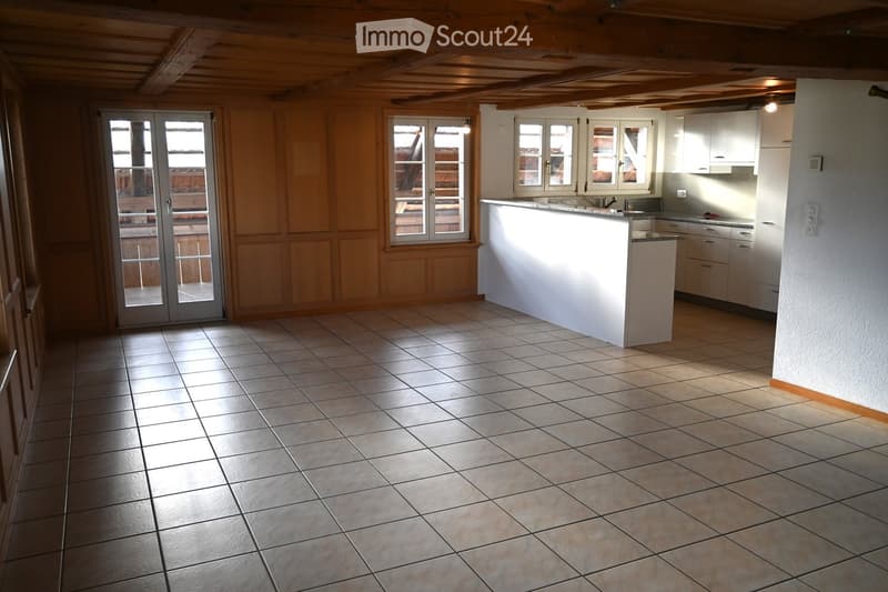 empty room, wooden ceiling, tiled floor, kitchen area, sliding glass doors
