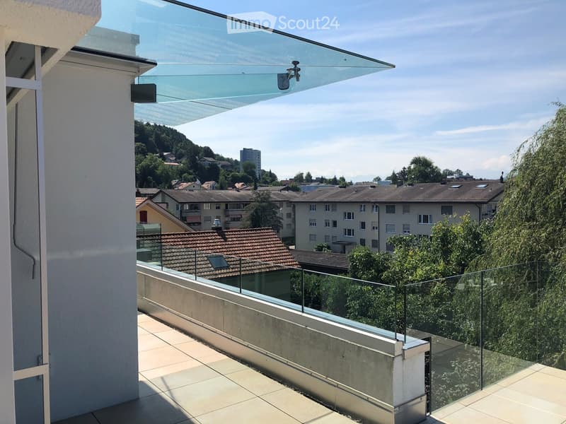 roof terrace with glass railings, tile flooring, view of mountains and cityscape