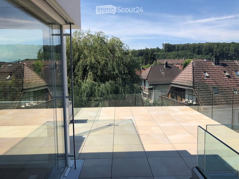 Glass balcony with glass railing, tiles, open view of the surroundings