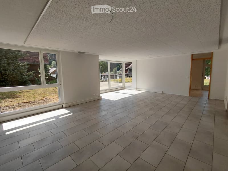 Empty room with large windows, tiled floor, and white walls. No furniture or equipment present.