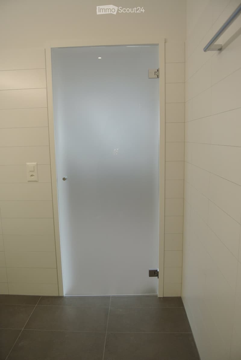 interior room, white tiled walls, white tiled floor, glass door, power outlet