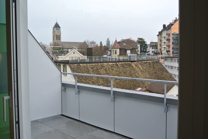 Metal railing, tile floor, view of city