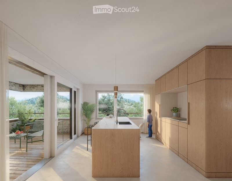 Modern kitchen with light wood cabinets, a central island, and large windows offering a scenic view. Includes a sink, pendant light, and a small seating area with a table and chairs.