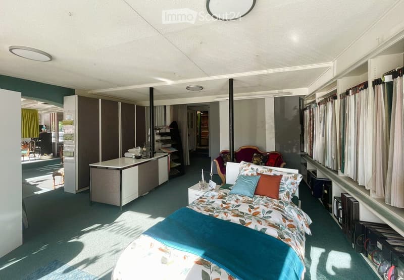 bedroom with bed, desk, wardrobes, and a window with curtains