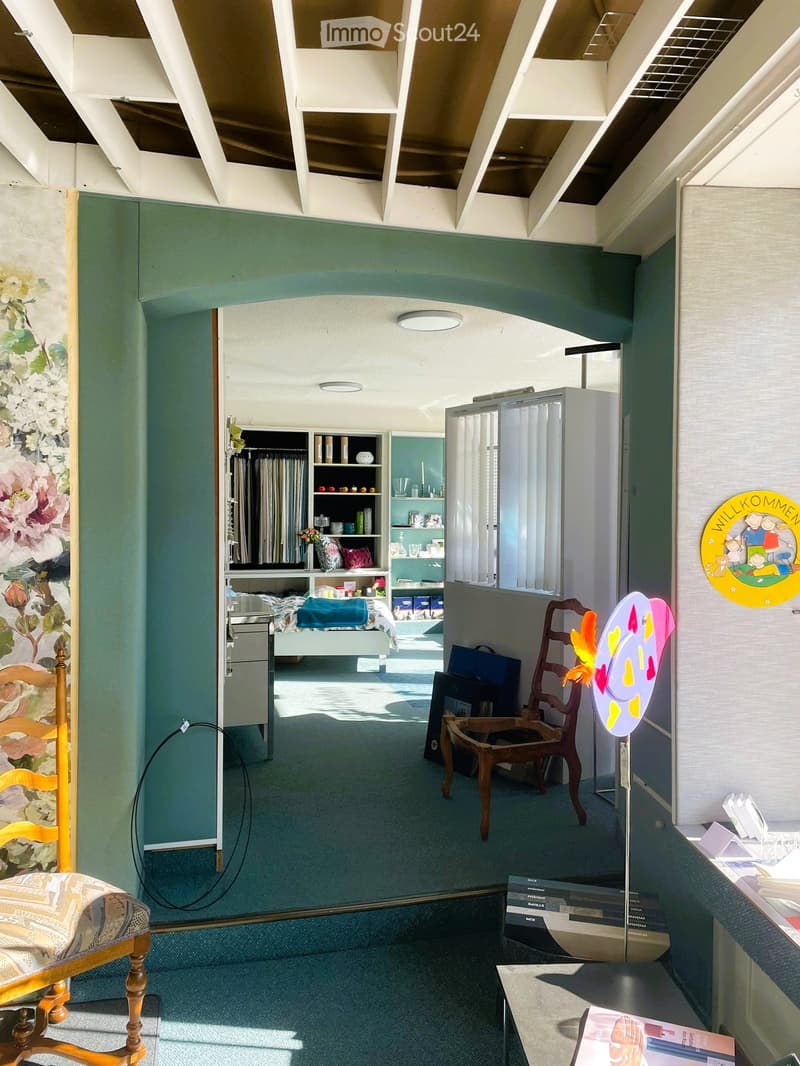 bedroom with bed, wardrobe, desk, chair, carpet, lamp, artwork, mirror, books, storage boxes