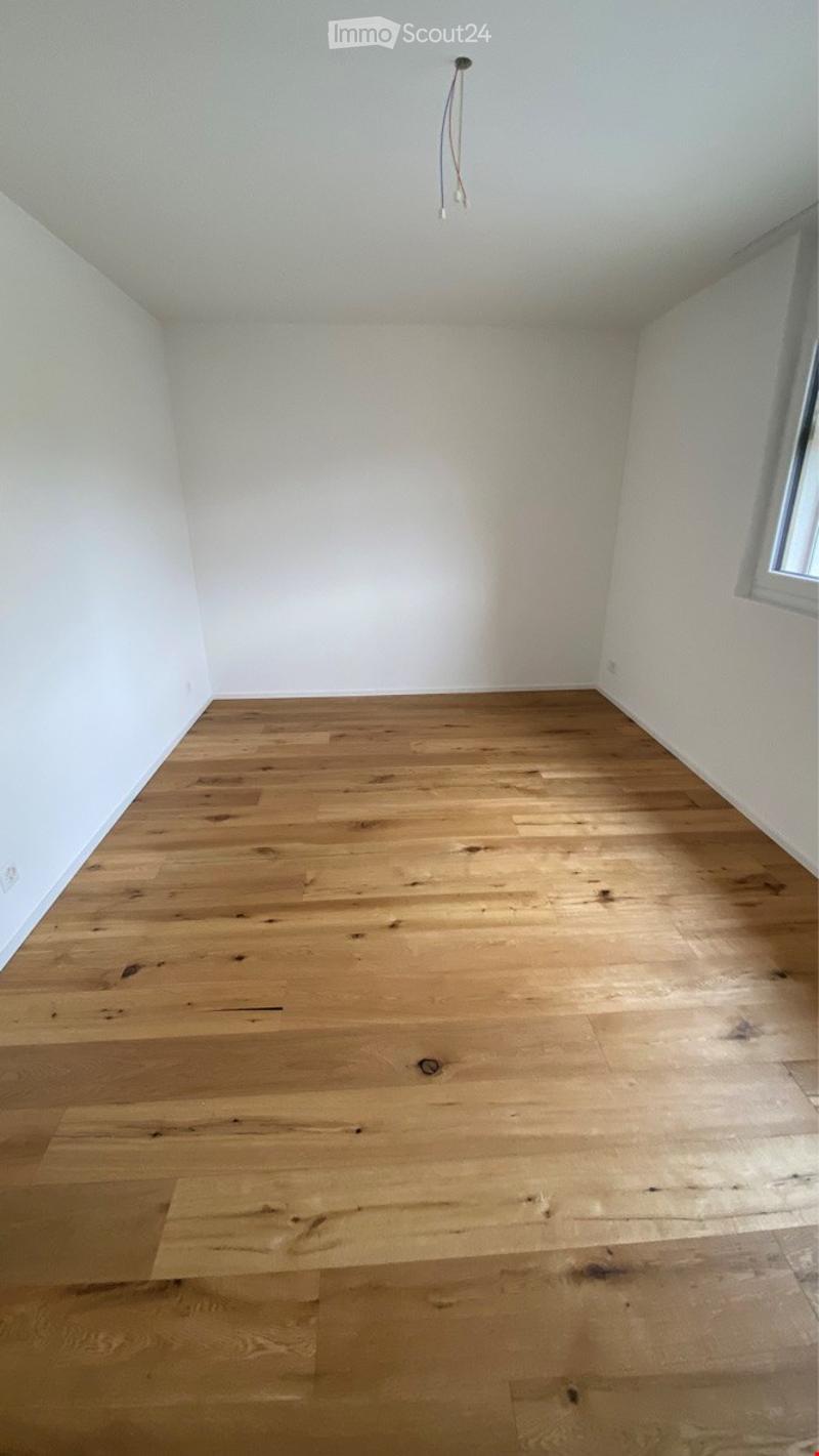 Completely empty room with bare white walls and light wooden floor. No furniture or equipment.